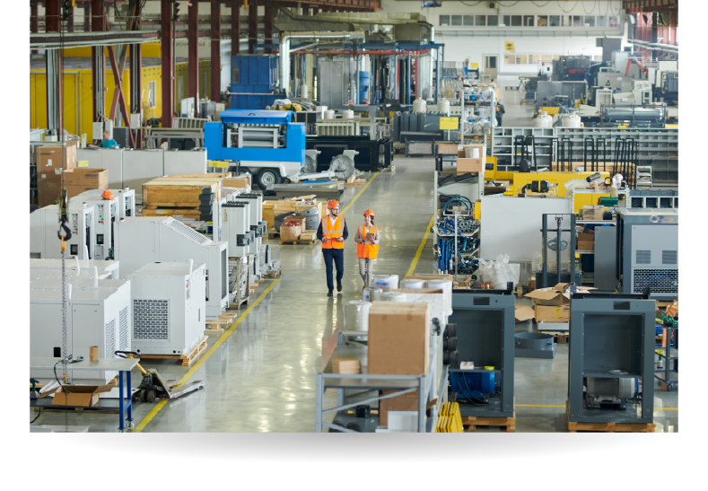 insurance brokers walking through an industrial manufacturing warehouse
